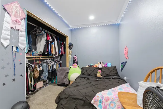 a bedroom with bed and a window