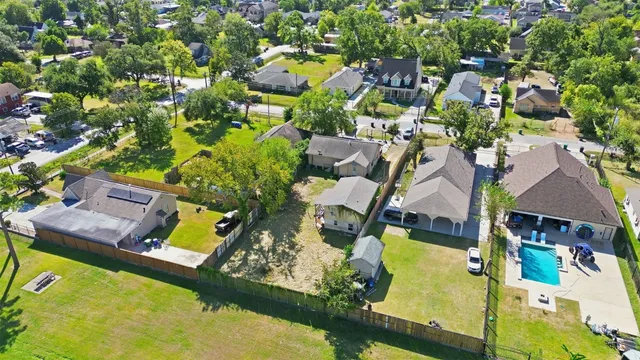 an aerial view of residential houses with yard
