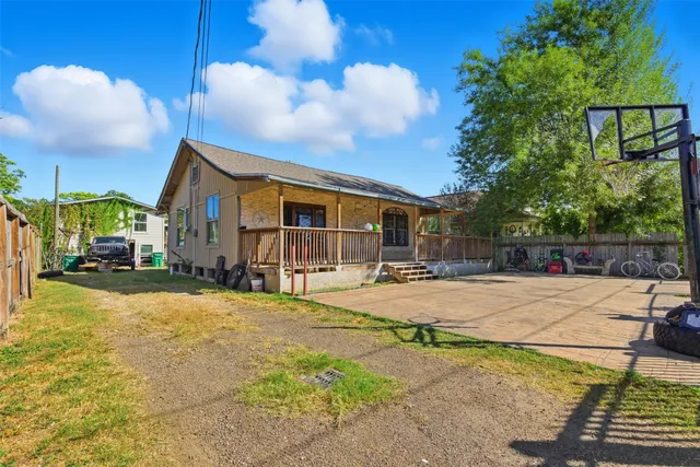 a swimming pool with outdoor seating and yard