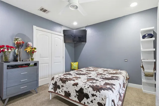 a bedroom with a bed and a dresser