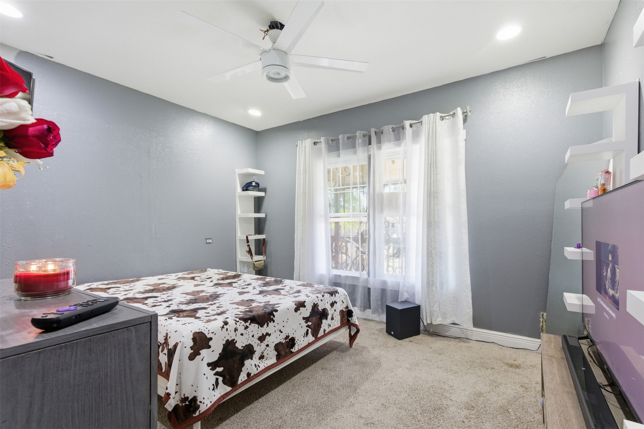 2017 Sadler Street Houston, TX 77093 - Photo 10 of 19 a bedroom with a bed and a chandelier