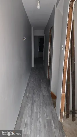 a workspace room with wooden floor and furniture