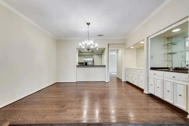 a large kitchen with granite countertop a dishwasher a stove a sink dishwasher and a fireplace with wooden floor