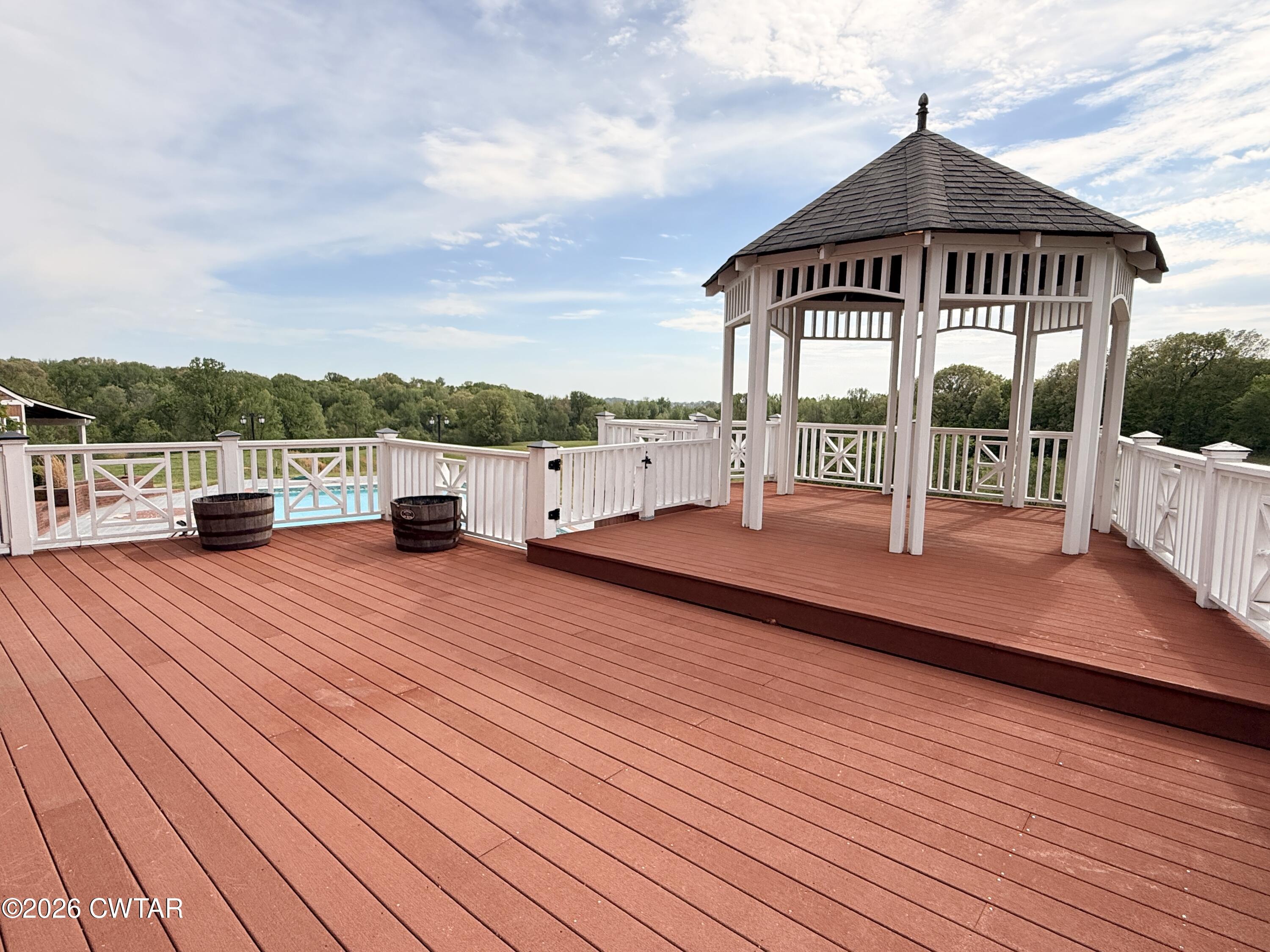2787 Meacham Road Dyersburg, TN 38024 - Photo 12 of 45 a view of a house with a wooden deck