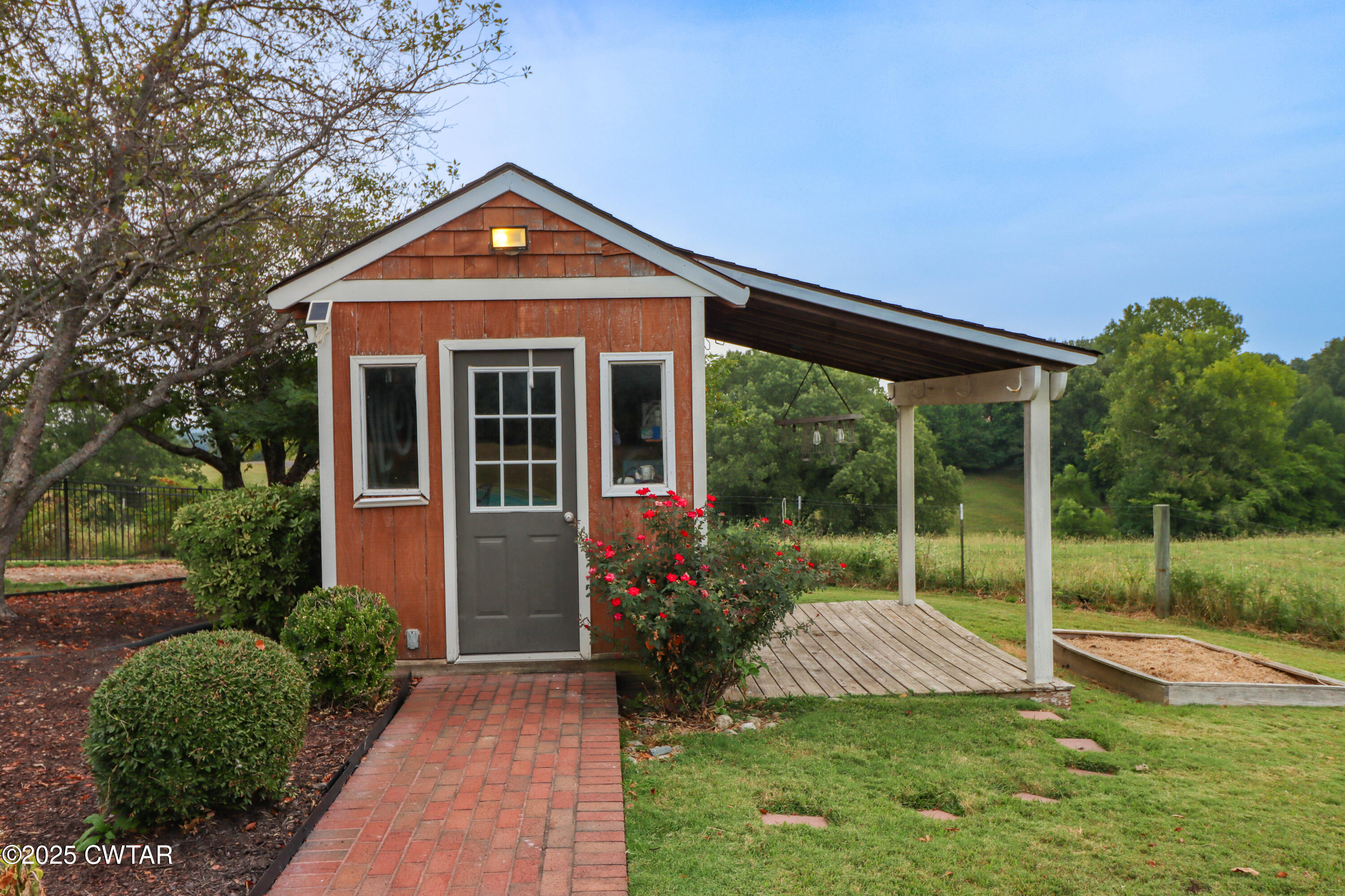 2787 Meacham Road Dyersburg, TN 38024 - Photo 13 of 45 a front view of a house with garden