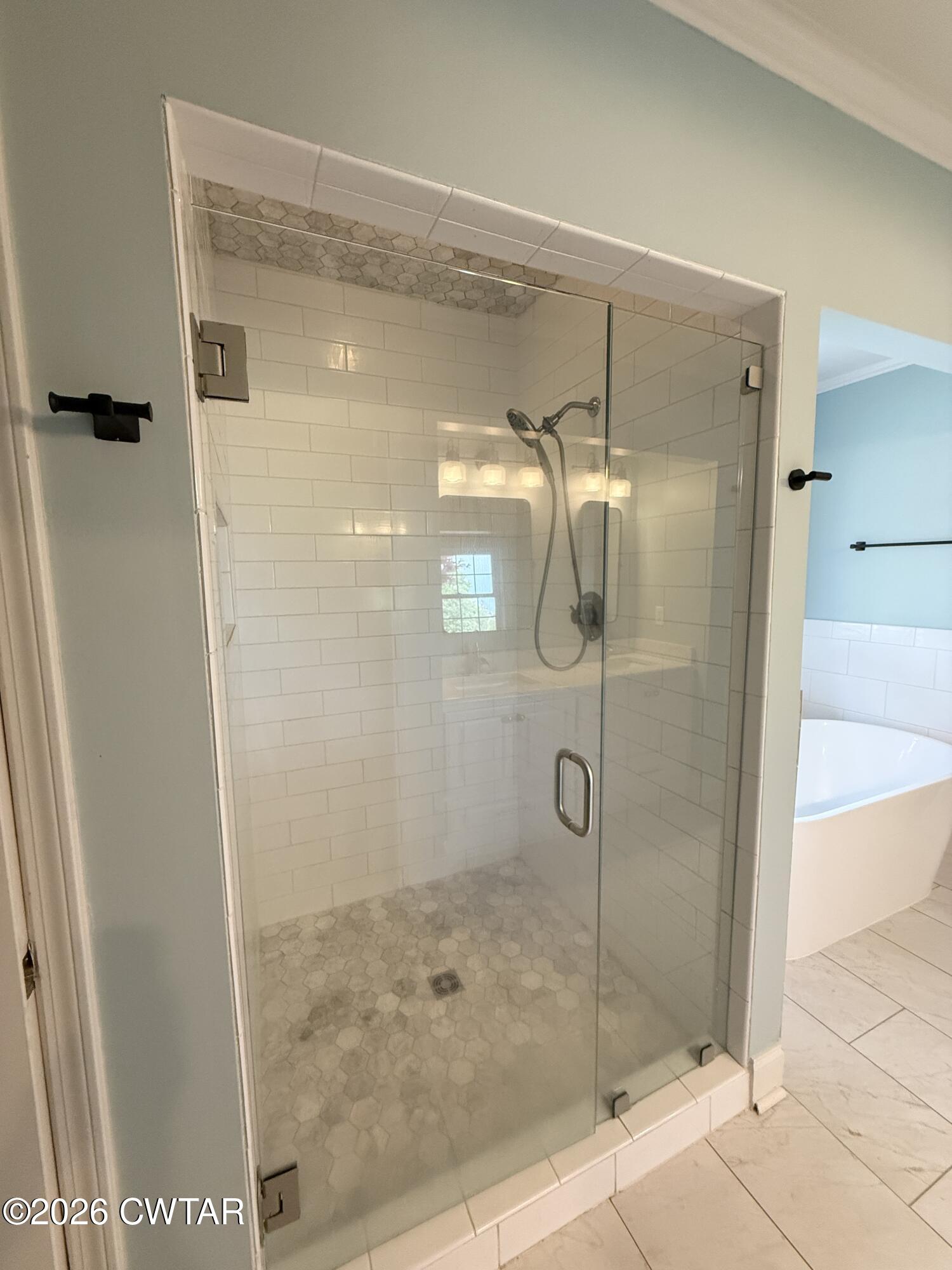 2787 Meacham Road Dyersburg, TN 38024 - Photo 29 of 45 a bathroom with a glass shower door