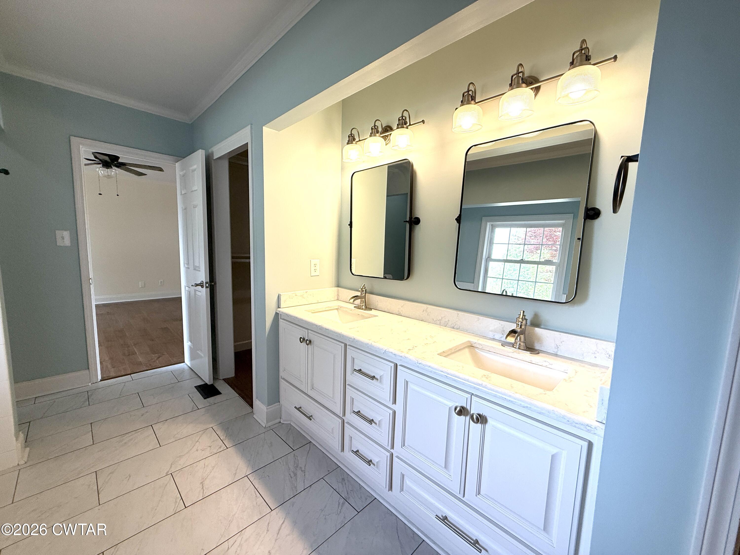 2787 Meacham Road Dyersburg, TN 38024 - Photo 30 of 45 a spacious bathroom with a double vanity sink and a mirror