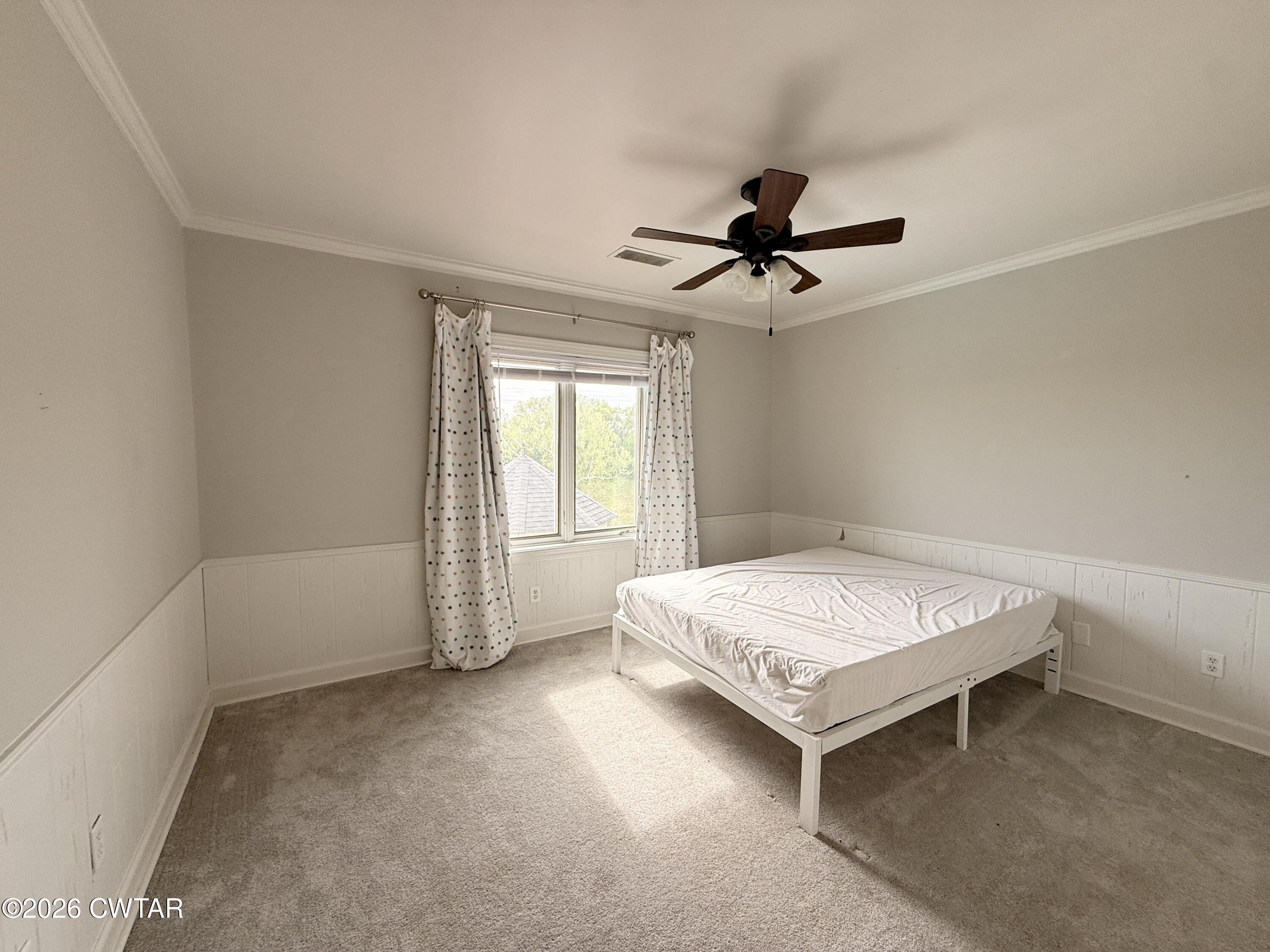 2787 Meacham Road Dyersburg, TN 38024 - Photo 37 of 45 a living room with a bed and a chandelier