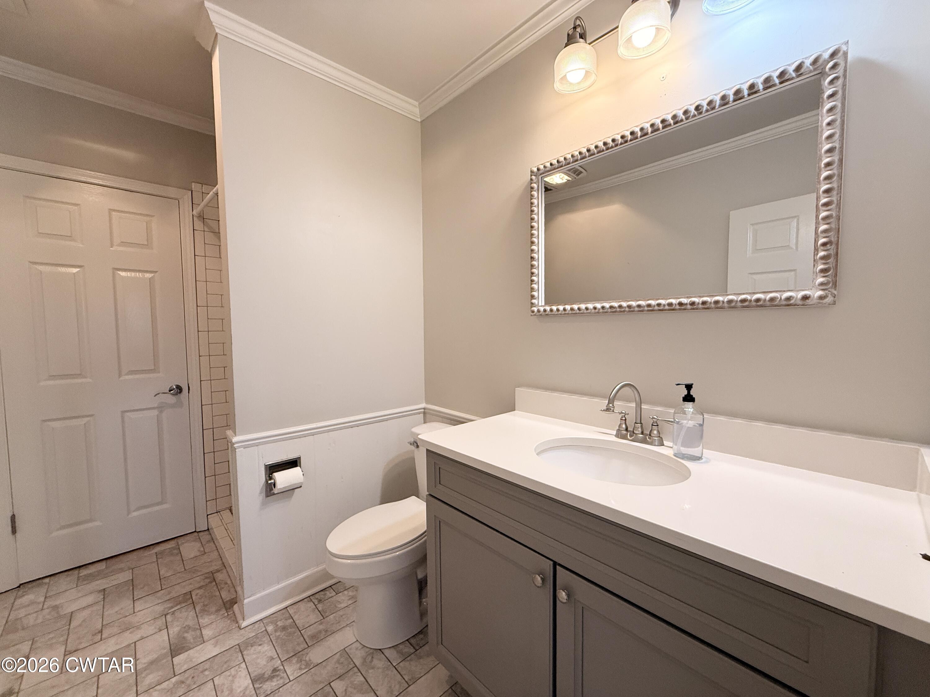 2787 Meacham Road Dyersburg, TN 38024 - Photo 41 of 45 a bathroom with a toilet a sink and mirror
