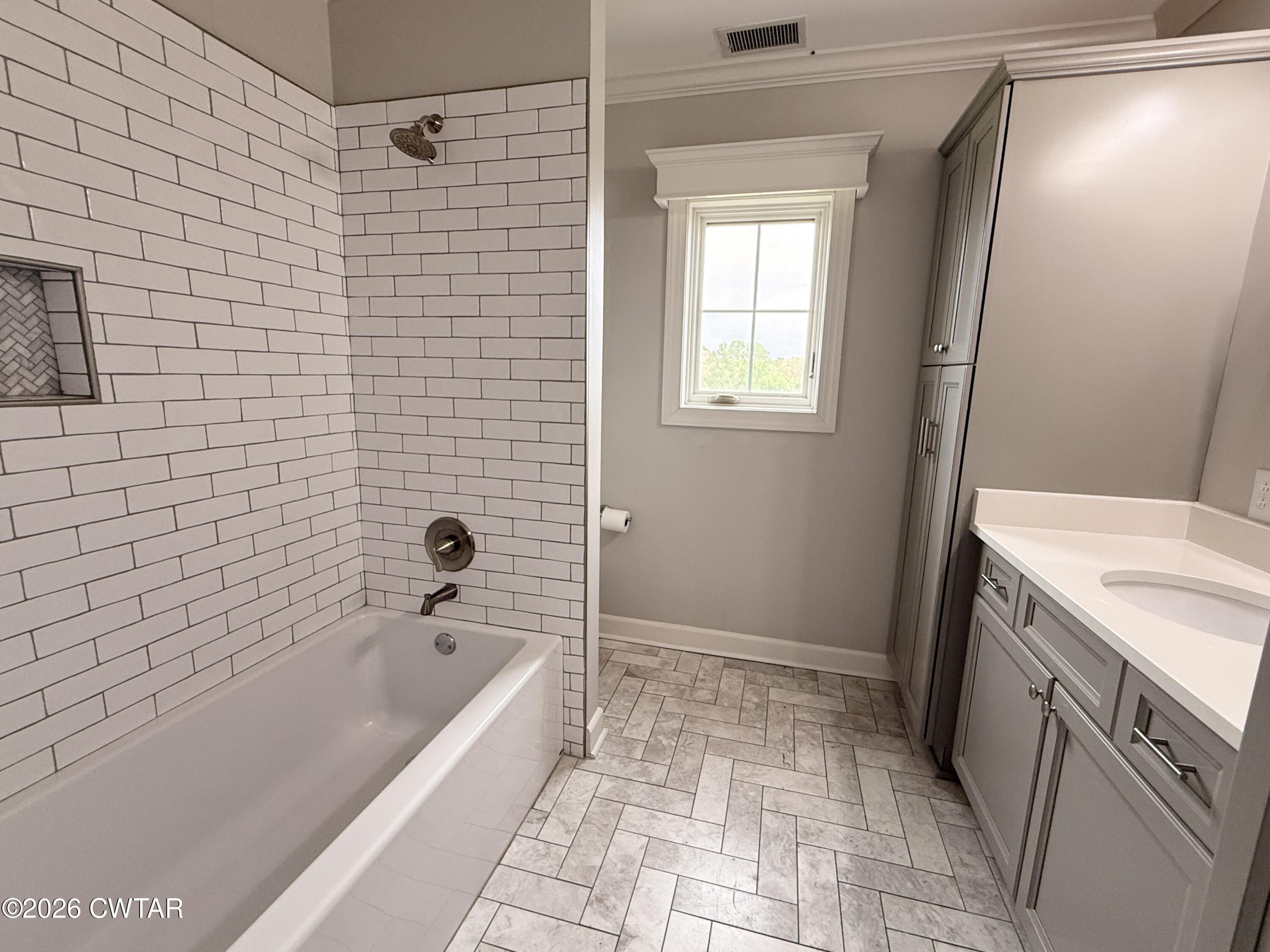 2787 Meacham Road Dyersburg, TN 38024 - Photo 43 of 45 a bathroom with a bathtub and a shower