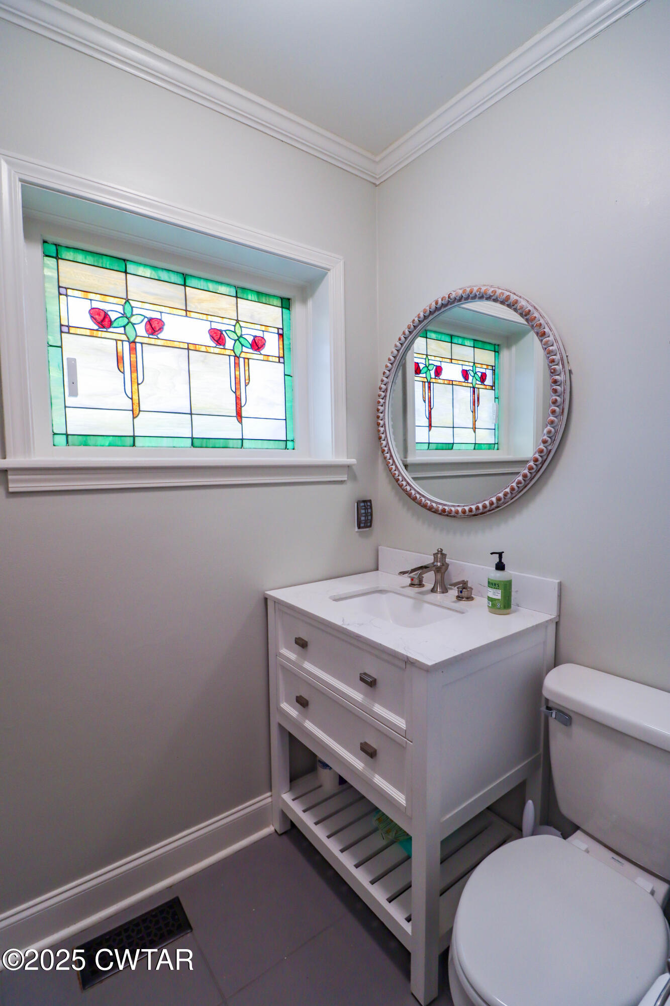 2787 Meacham Road Dyersburg, TN 38024 - Photo 44 of 45 a bathroom with a sink a toilet and a window