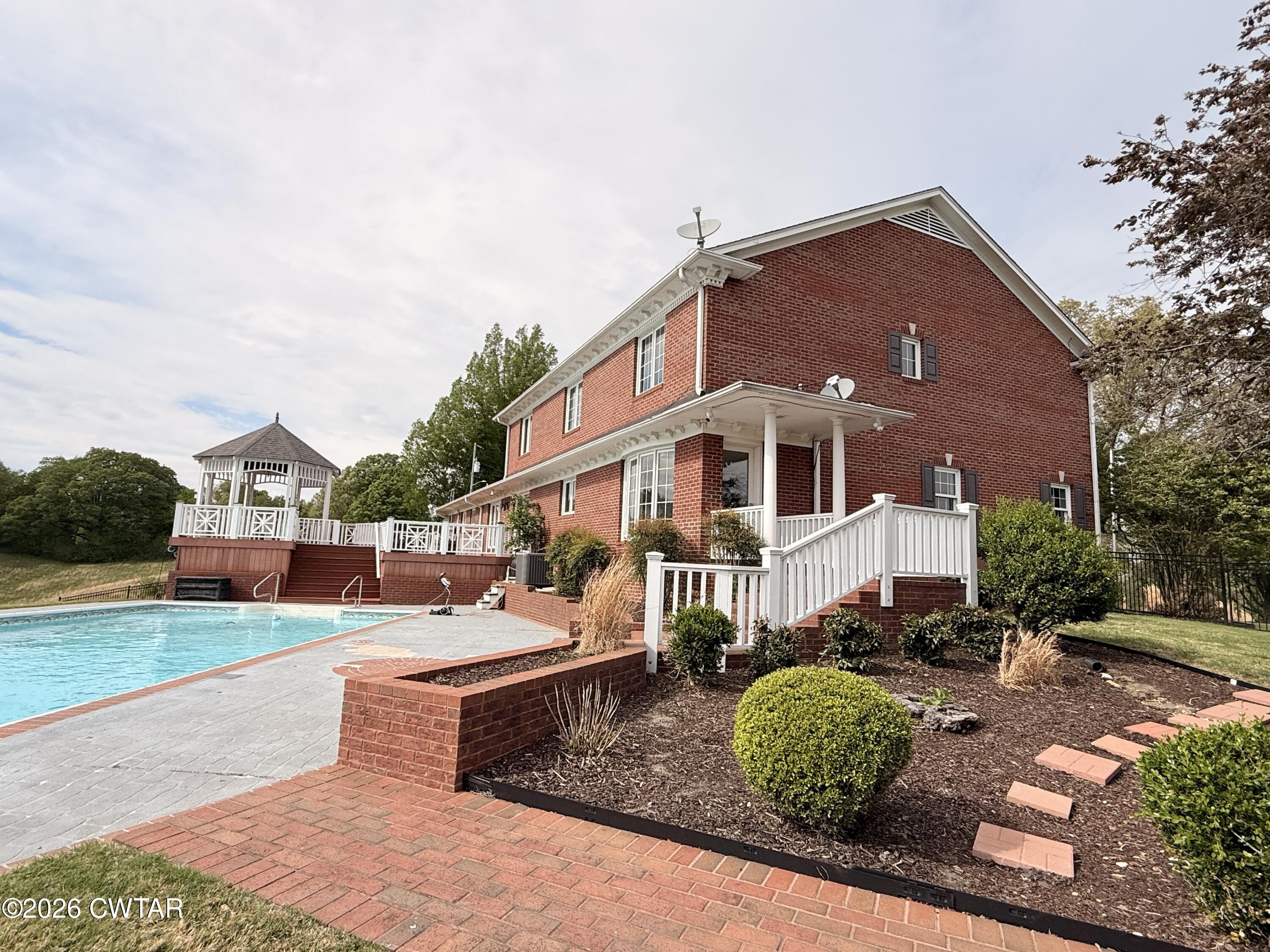 2787 Meacham Road Dyersburg, TN 38024 - Photo 9 of 45 a front view of a house with garden