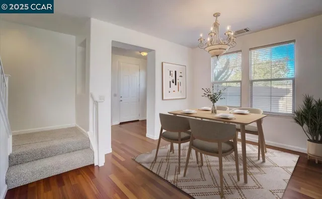 a view of a dining room with furniture wooden floor and chandelier