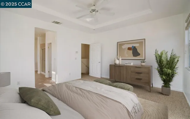 a bedroom with a bed potted plant and a dresser