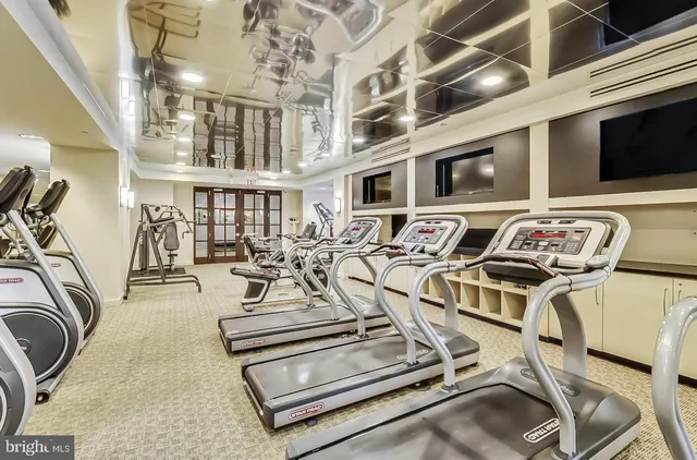 a living room with furniture a bookshelf and a book shelf