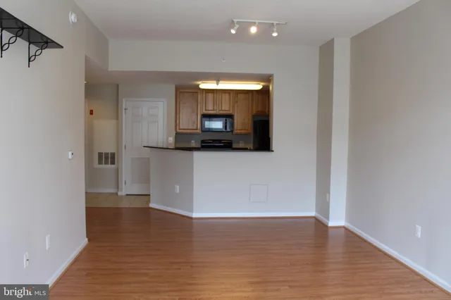 a view of a kitchen from a hallway