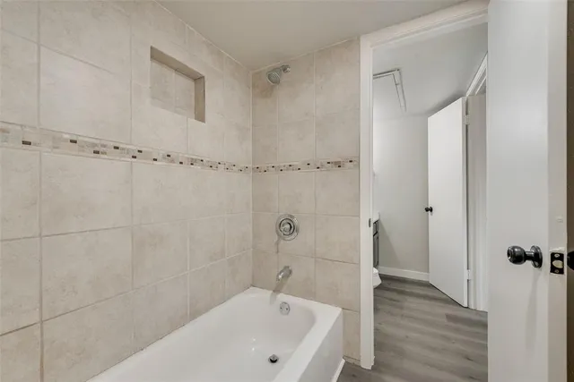 a bathroom with a bathtub and a shower