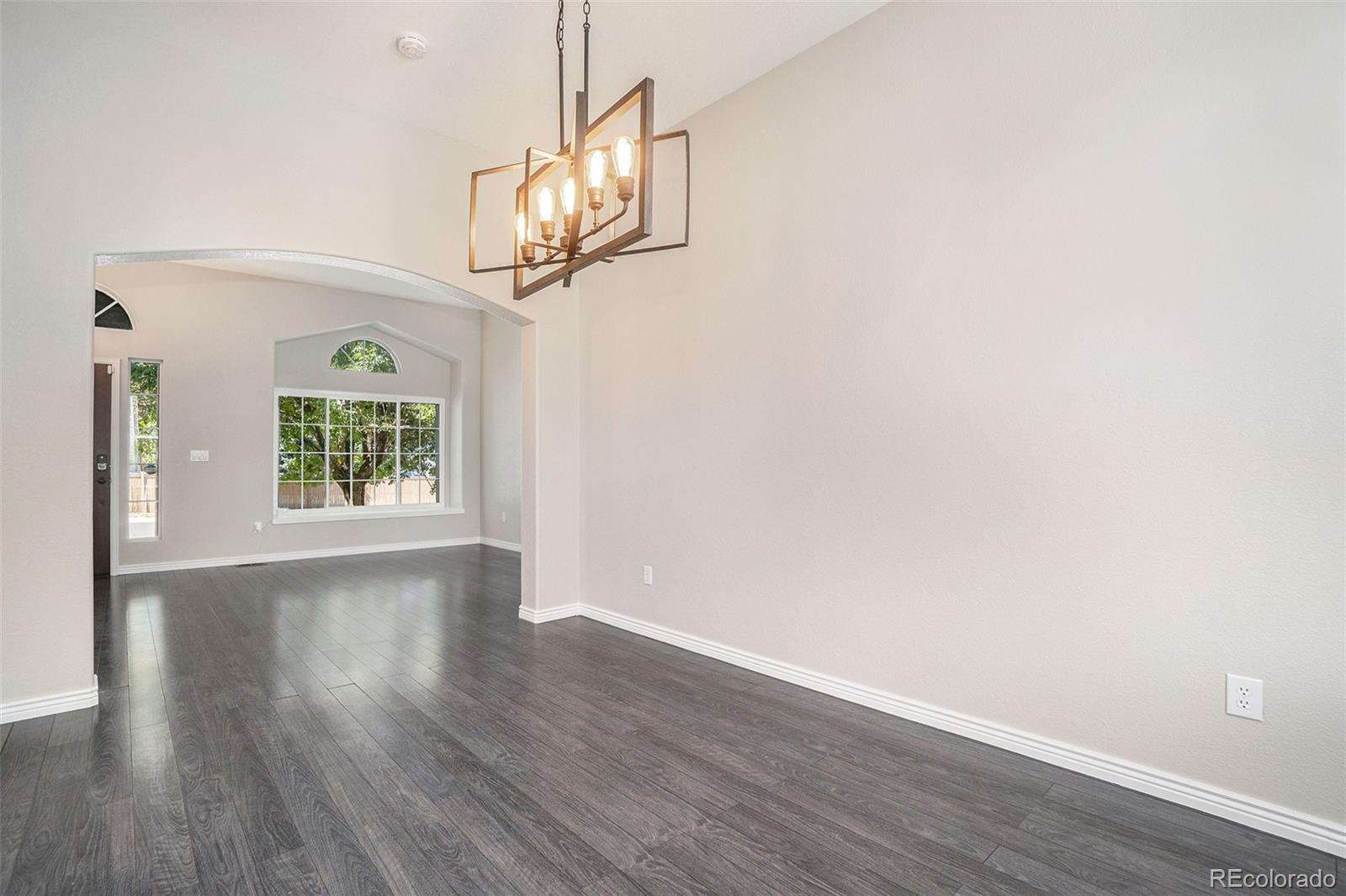 6000 South Summer Ridge Way Castle Rock, CO 80109 - Photo 11 of 19 a view of an empty room with wooden floor and a window