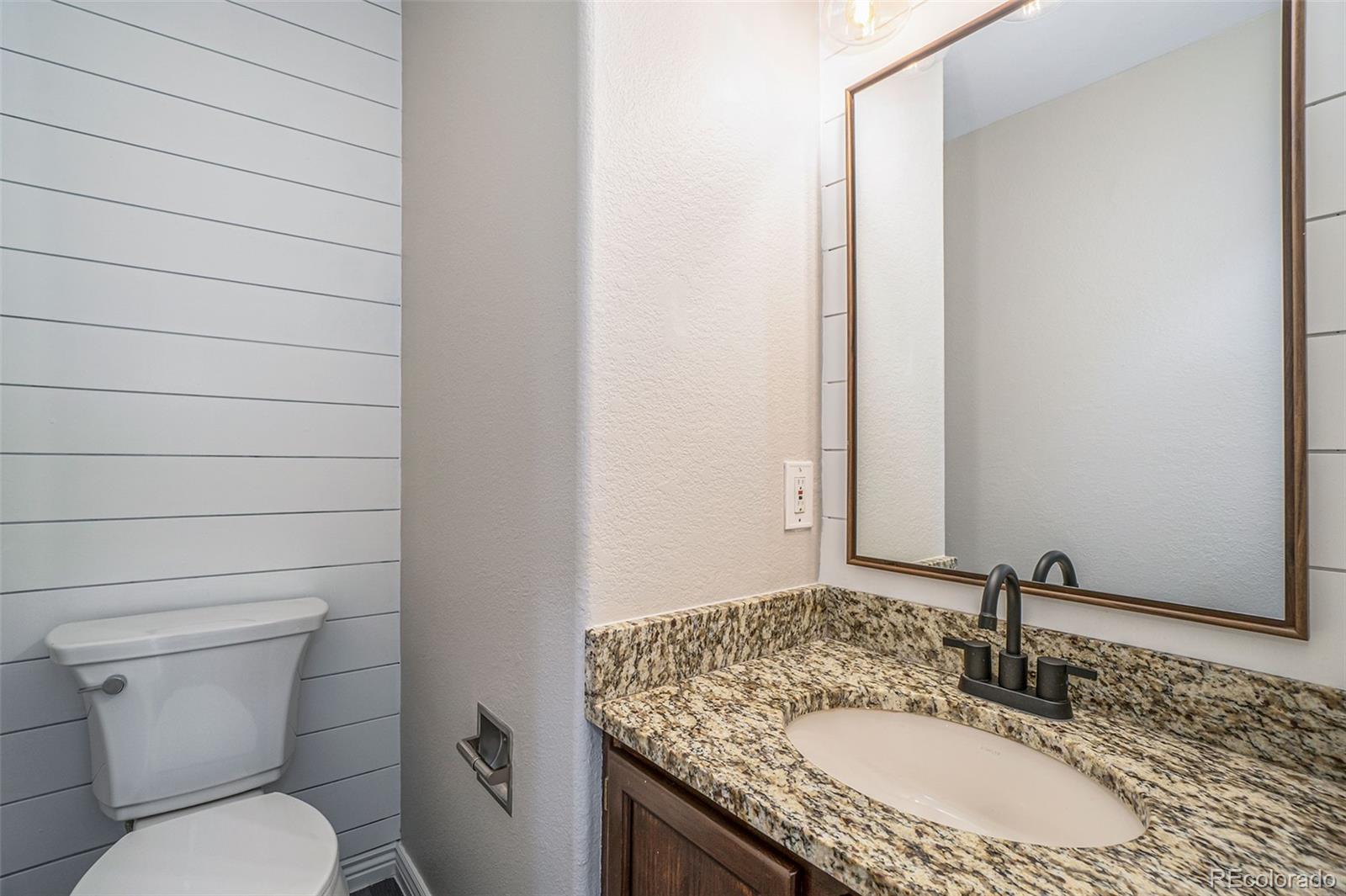 6000 South Summer Ridge Way Castle Rock, CO 80109 - Photo 14 of 19 a bathroom with a granite countertop sink and a mirror