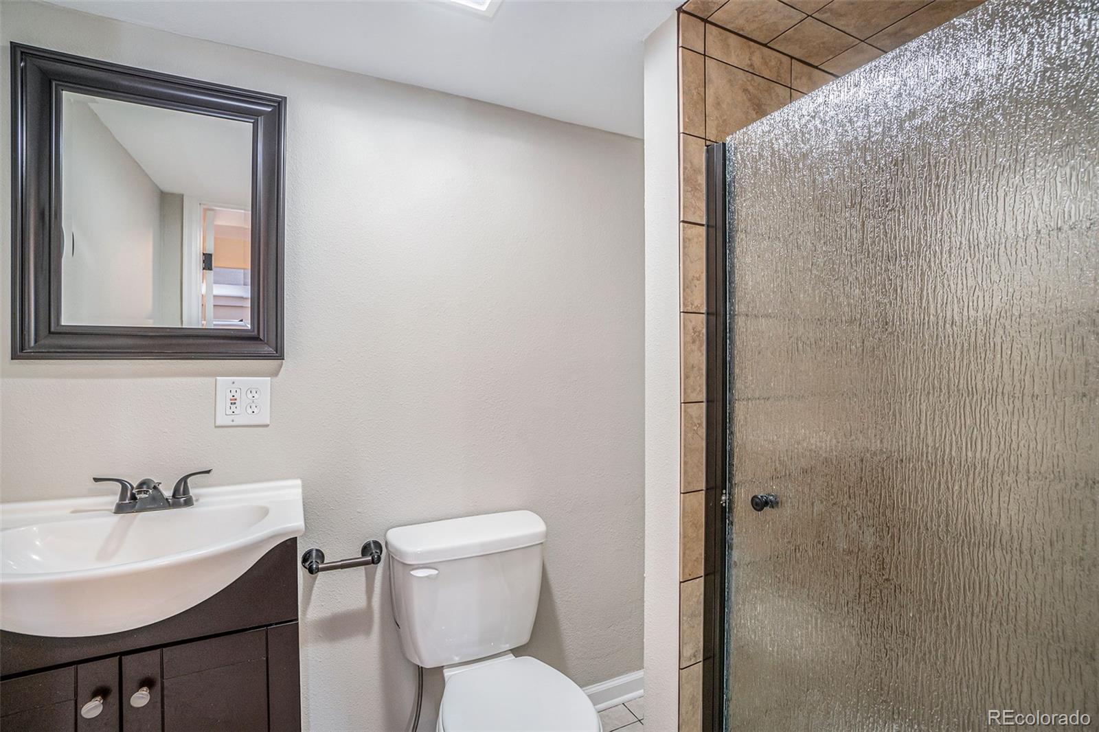 6000 South Summer Ridge Way Castle Rock, CO 80109 - Photo 18 of 19 a bathroom with a toilet a sink and mirror