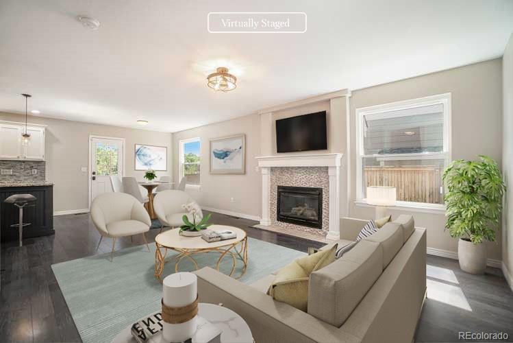 6000 South Summer Ridge Way Castle Rock, CO 80109 - Photo 2 of 19 a living room with furniture a fireplace and a flat screen tv