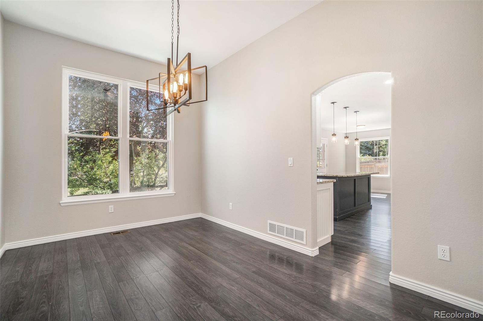 6000 South Summer Ridge Way Castle Rock, CO 80109 - Photo 10 of 19 an empty room with wooden floor and windows