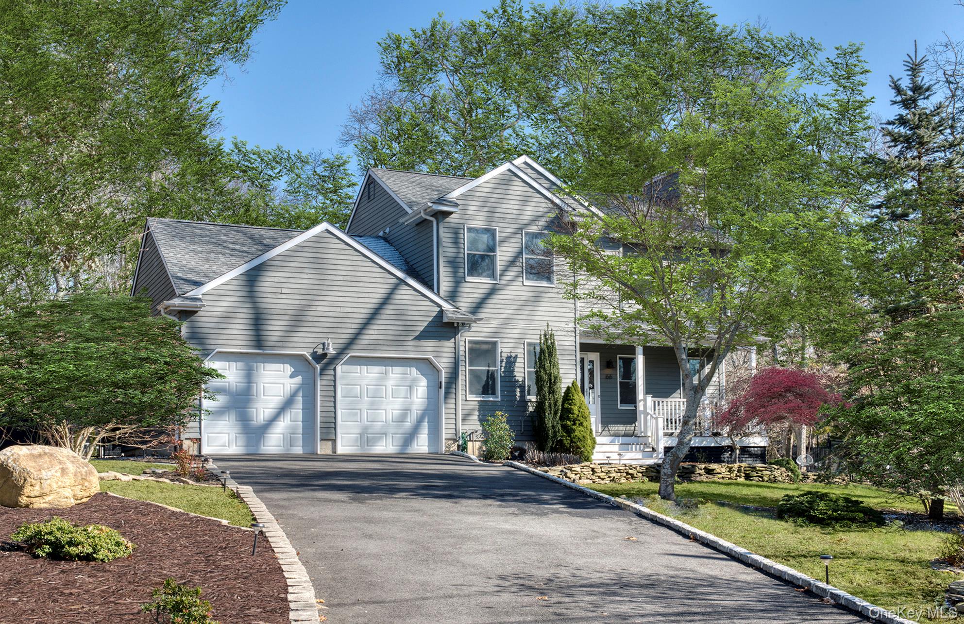 66 Knoll Road Southampton, NY 11968 - Photo 1 of 31 a front view of a house with garden