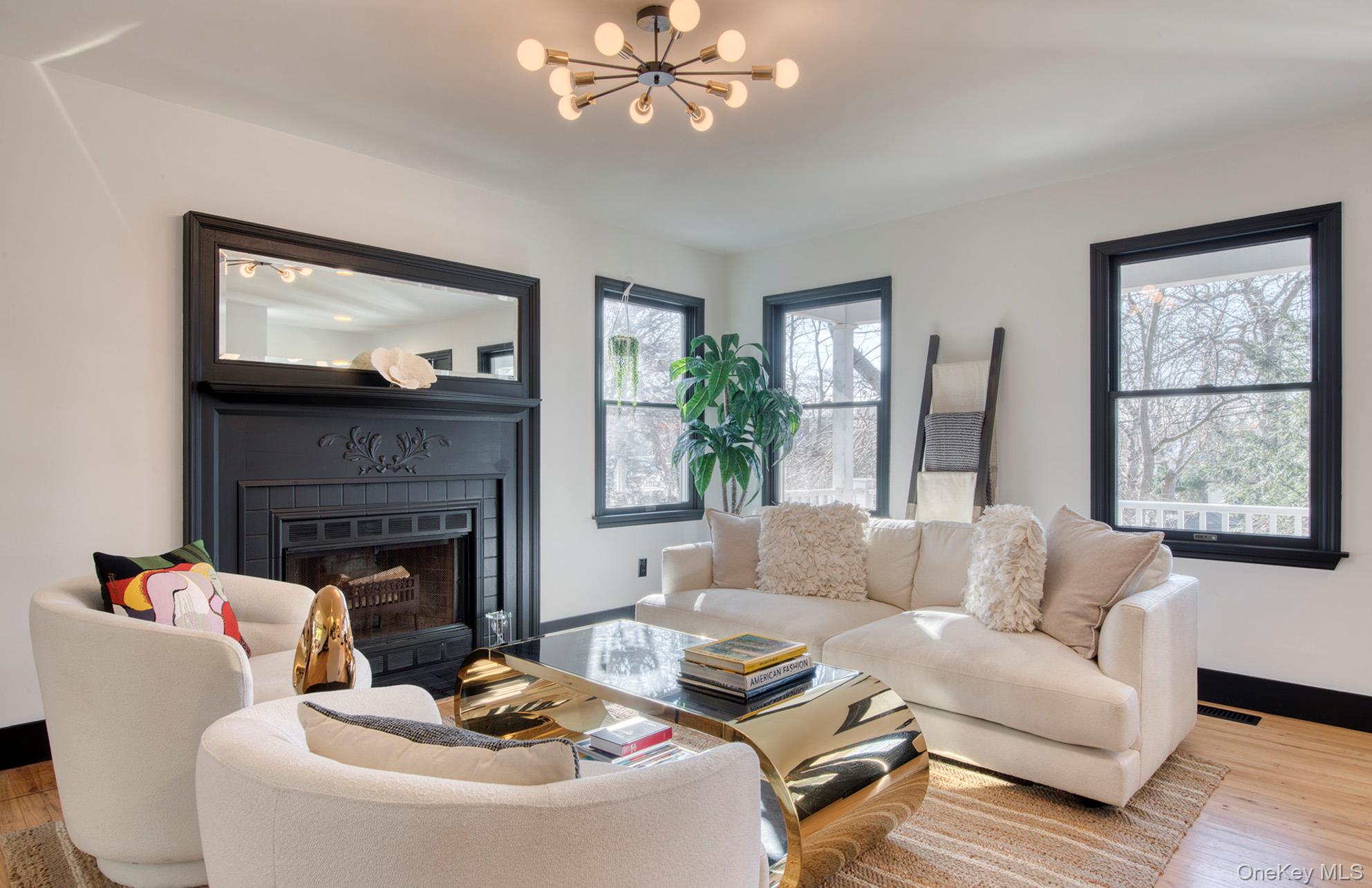 66 Knoll Road Southampton, NY 11968 - Photo 12 of 31 a living room with furniture a fireplace and a large mirror
