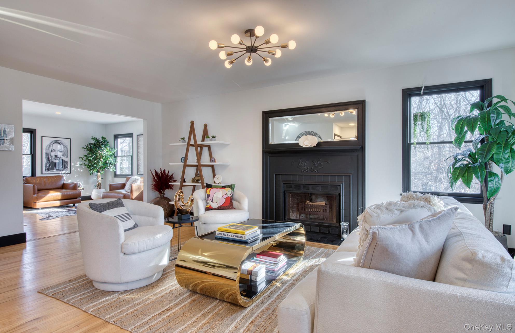 66 Knoll Road Southampton, NY 11968 - Photo 13 of 31 a living room with furniture a fireplace and a flat screen tv