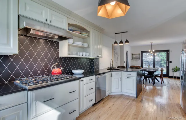 a kitchen with stainless steel appliances a stove sink and cabinets