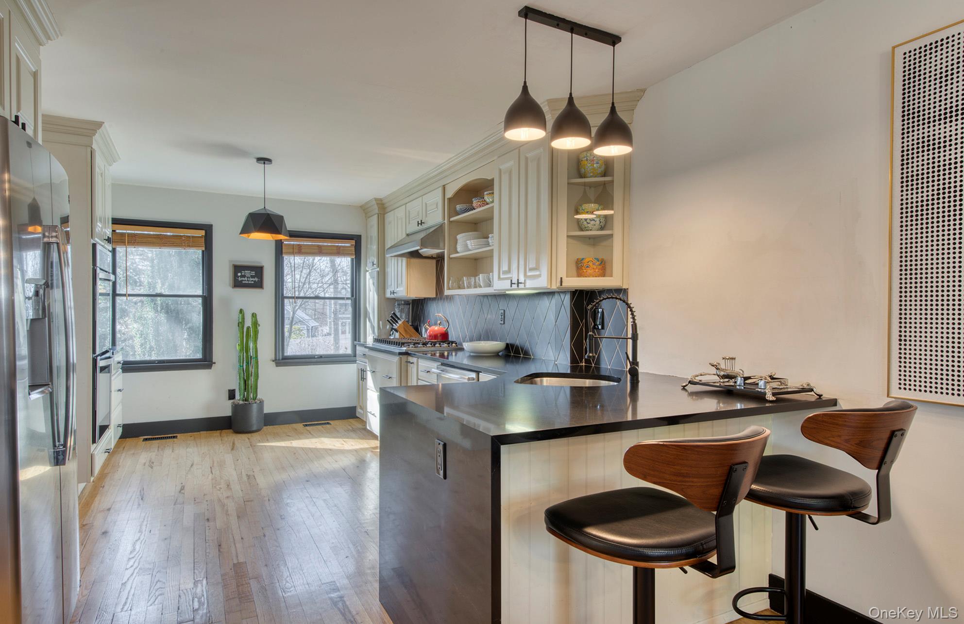 66 Knoll Road Southampton, NY 11968 - Photo 17 of 31 a kitchen with stainless steel appliances granite countertop a stove a sink and a refrigerator