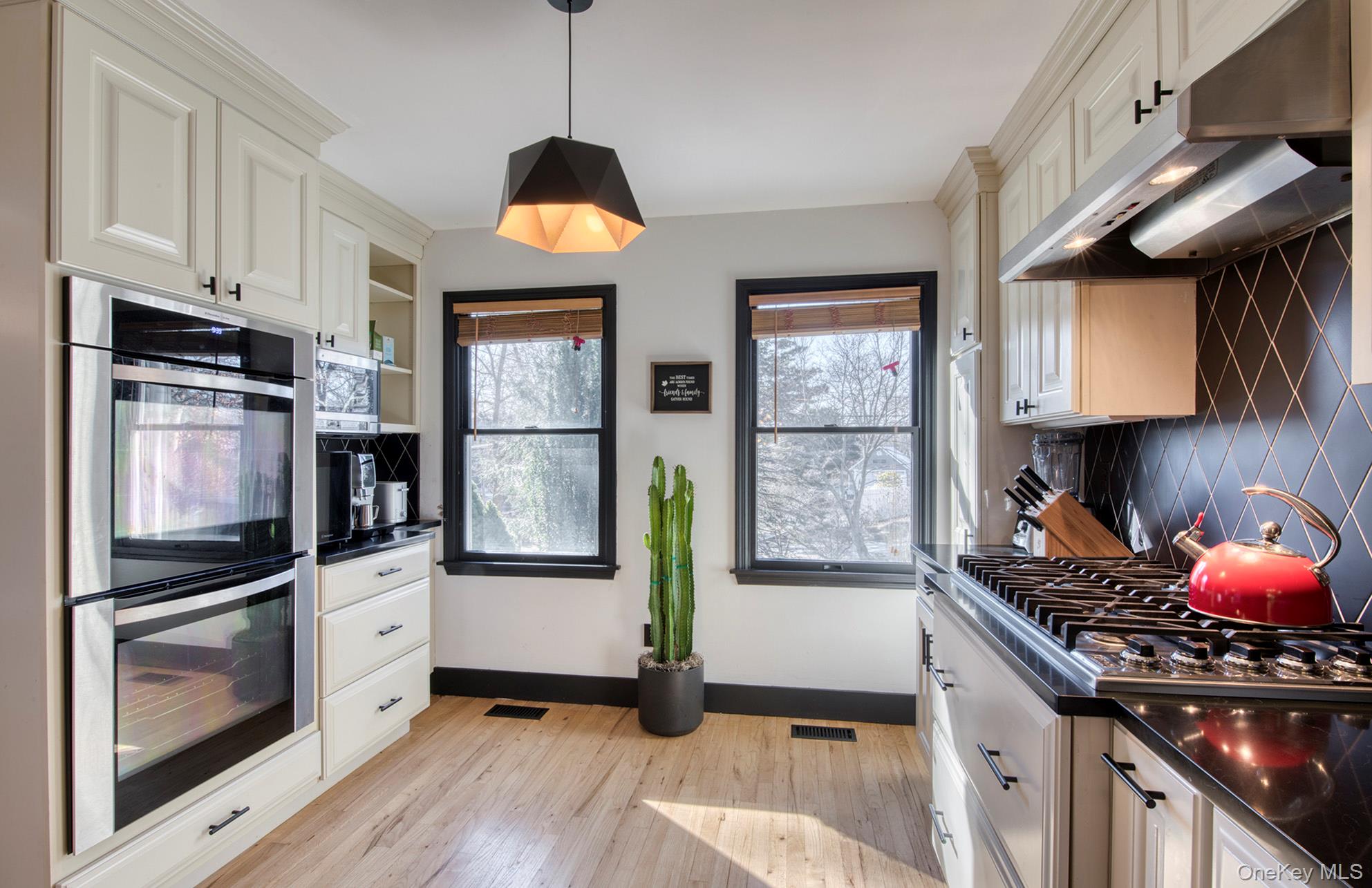66 Knoll Road Southampton, NY 11968 - Photo 18 of 31 a kitchen with stainless steel appliances granite countertop a stove a sink and a microwave
