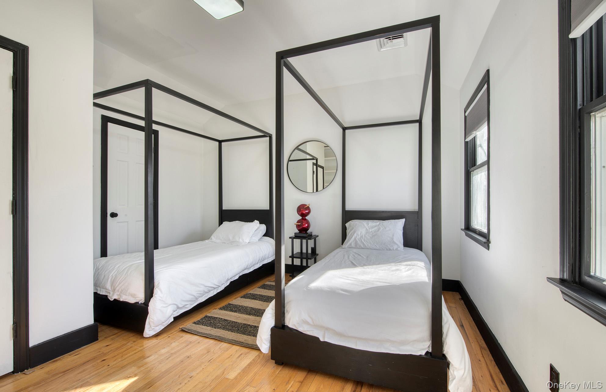 66 Knoll Road Southampton, NY 11968 - Photo 20 of 31 a bedroom with bed and a mirror on the dresser