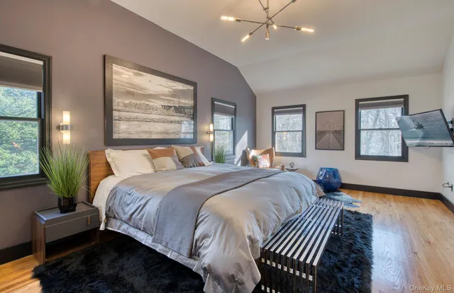 a bedroom with bed and wooden floor