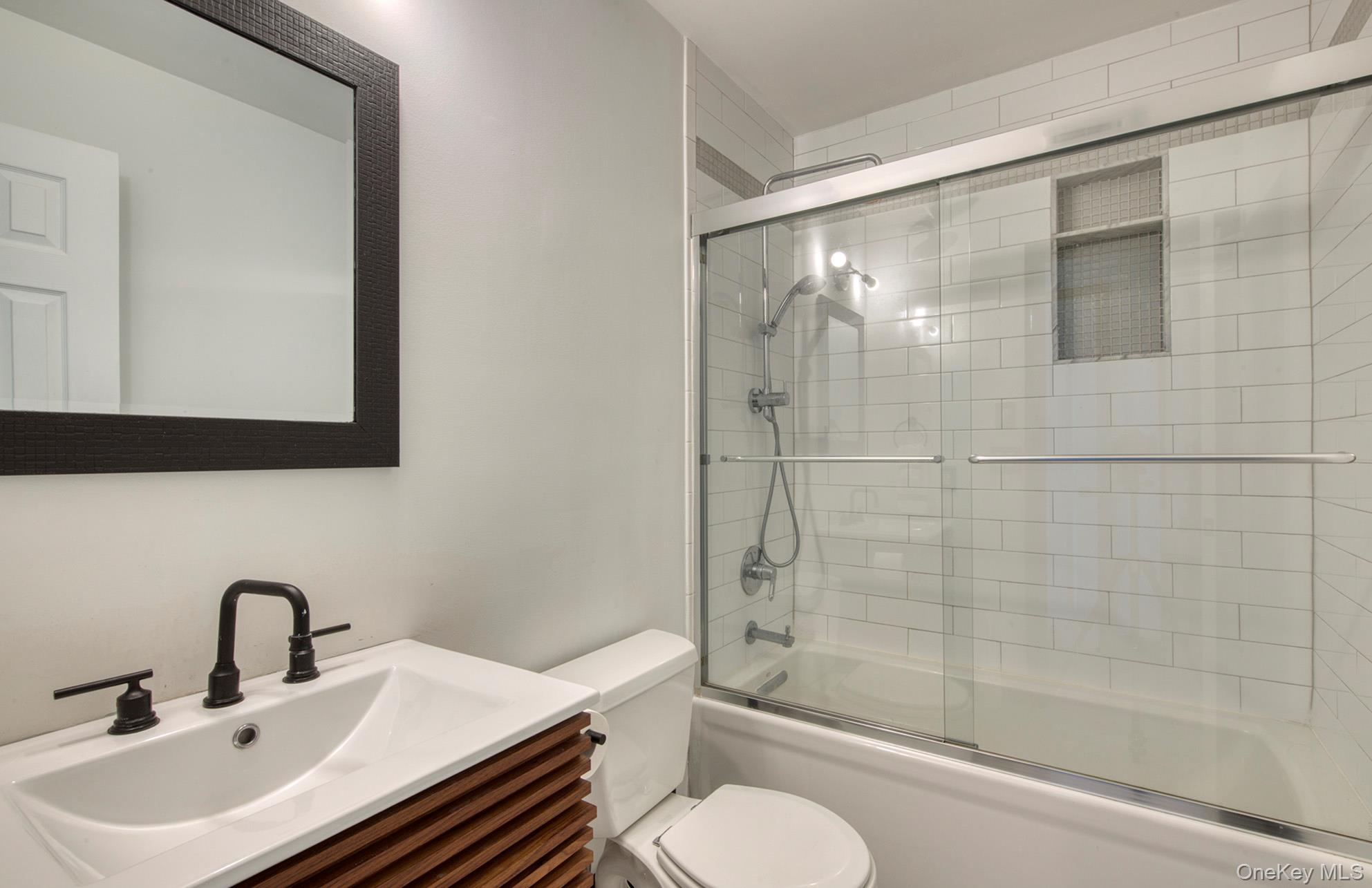 66 Knoll Road Southampton, NY 11968 - Photo 25 of 31 a bathroom with a sink toilet and shower