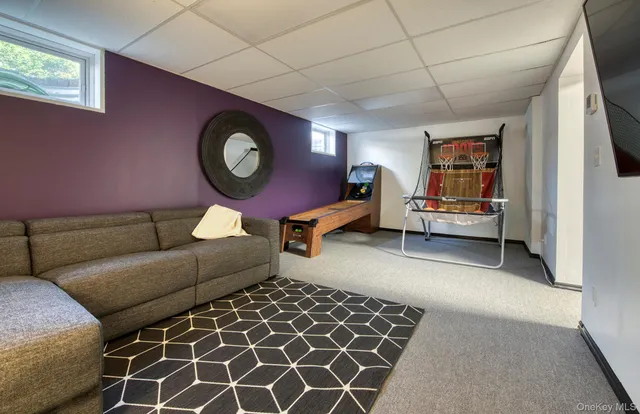 a living room with furniture and a clock