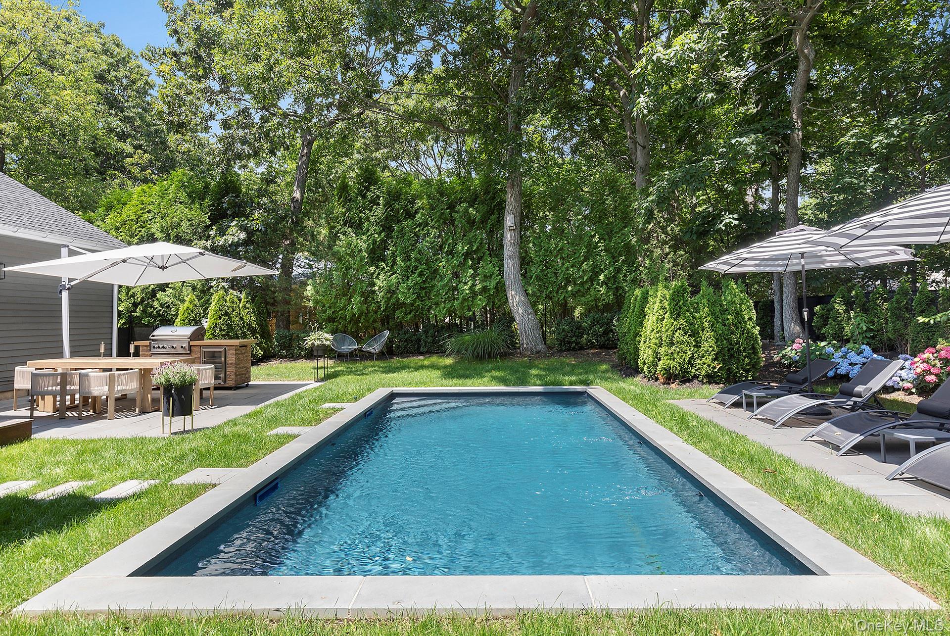 66 Knoll Road Southampton, NY 11968 - Photo 3 of 31 a view of a house with swimming pool and sitting area