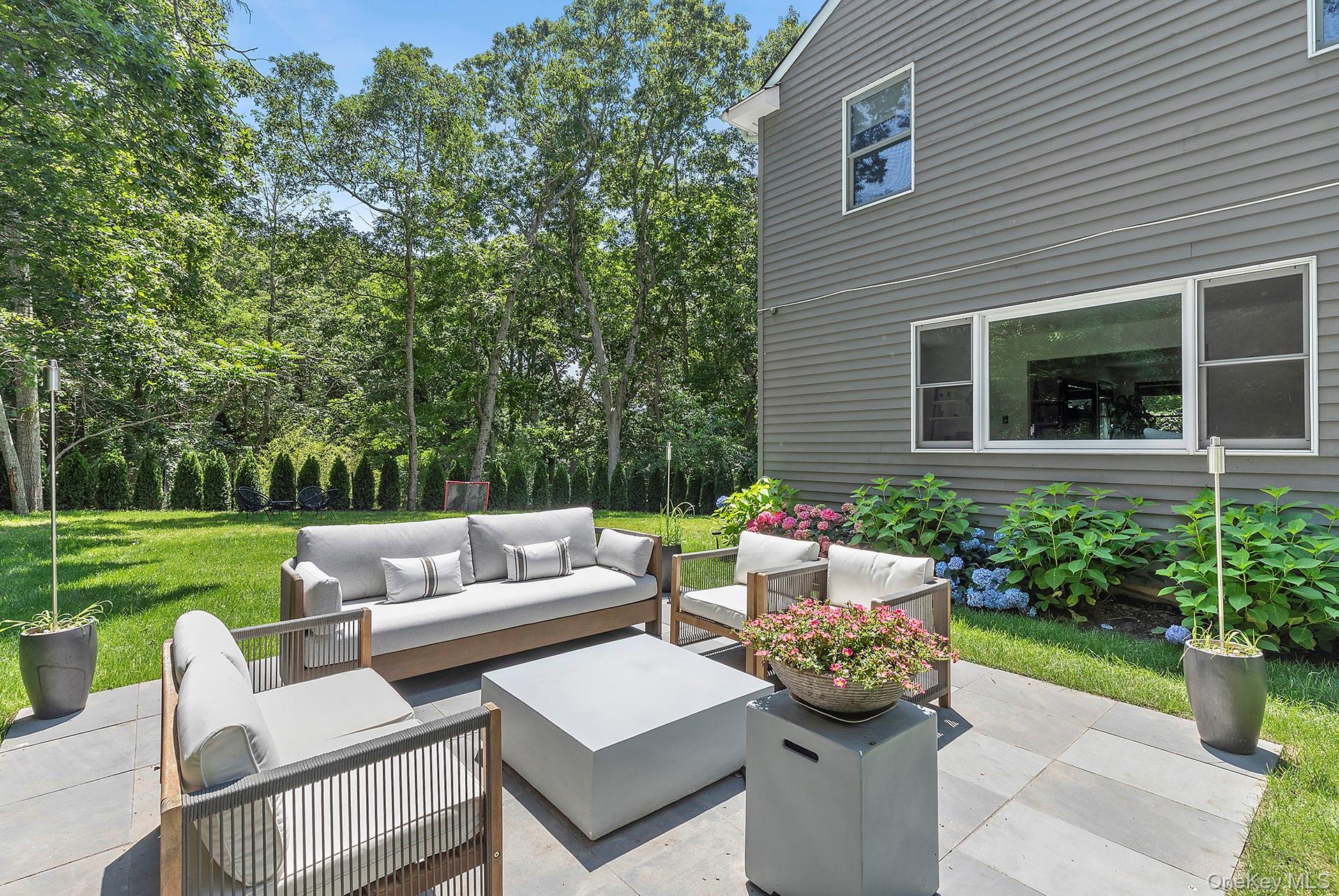 66 Knoll Road Southampton, NY 11968 - Photo 6 of 31 a view of a patio with a chairs and a table and chair