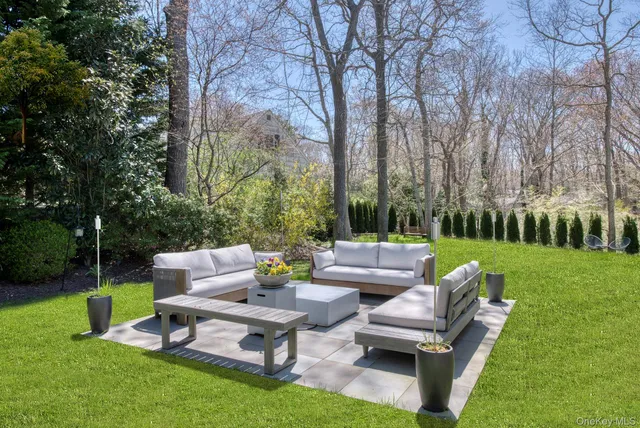 a view of a patio with couches and a table and chairs with the garden