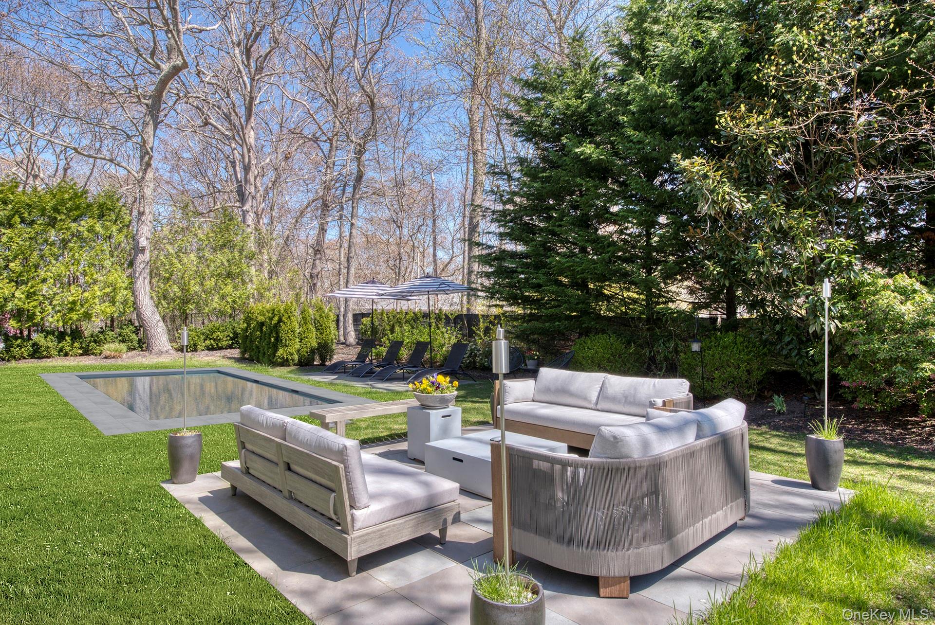 66 Knoll Road Southampton, NY 11968 - Photo 8 of 31 a view of a fountain with a couches in a patio