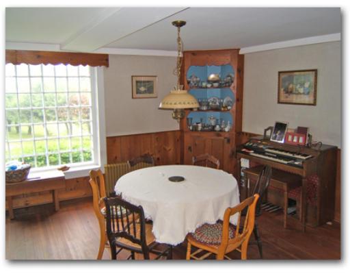 78 Ashfield Road Buckland, MA 01370 - Photo 3 of 7 a living room with a couch a chandelier and a large window