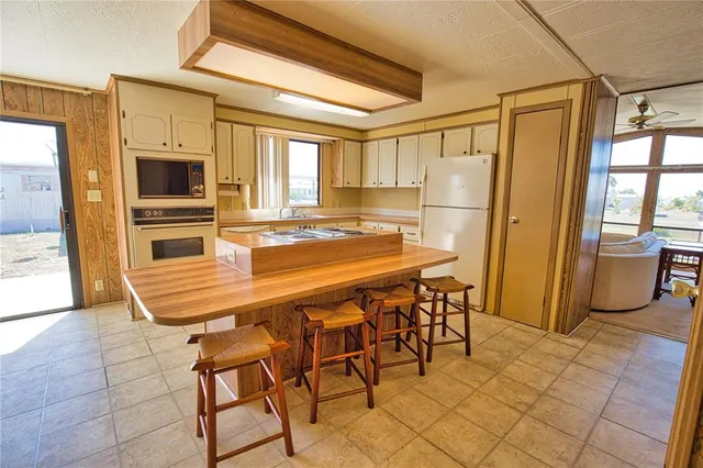 a table and chairs in a kitchen next to a window