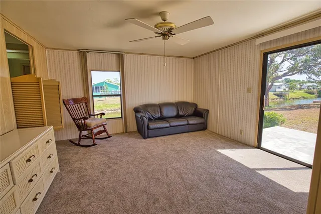 a living room with furniture and a floor to ceiling window