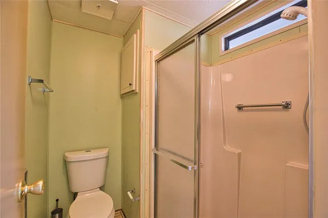 a bathroom with a toilet and a shower