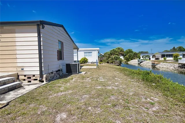 a backyard of a house with yard and outdoor seating