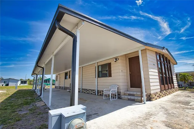 a backyard of a house with outdoor seating