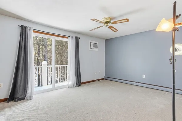 a view of a livingroom with a ceiling fan and window