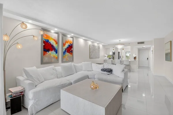 a living room with furniture and kitchen view