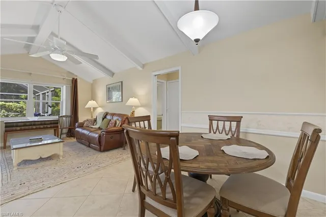a view of a dining room with furniture and a window