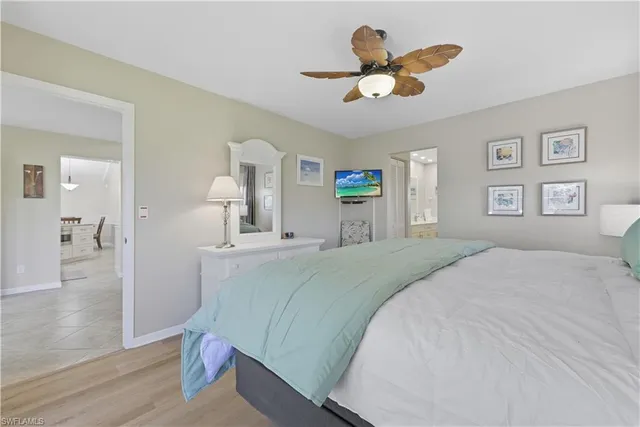 a bed room with a bed and a chandelier